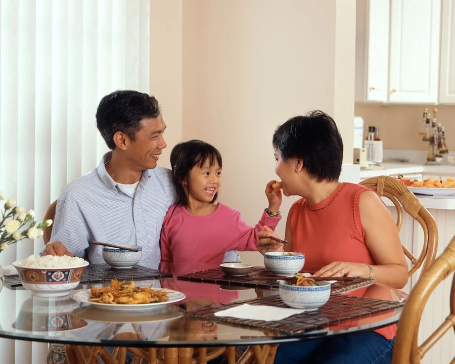 Two housing workers talking in a warmly lit community office